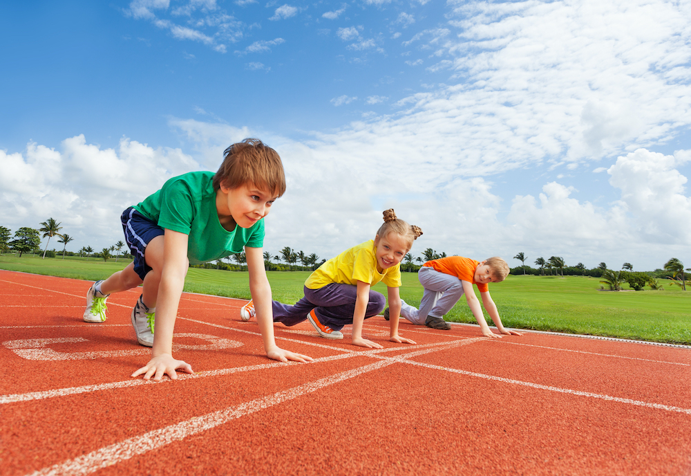 kids on track at starting line ready to run