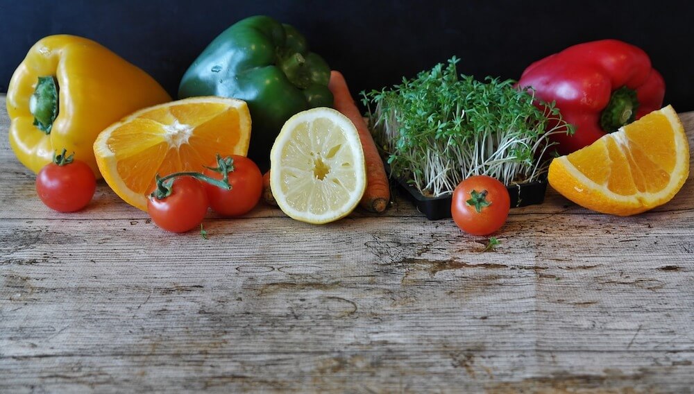 Healthy fruits and vegetables on wooden table